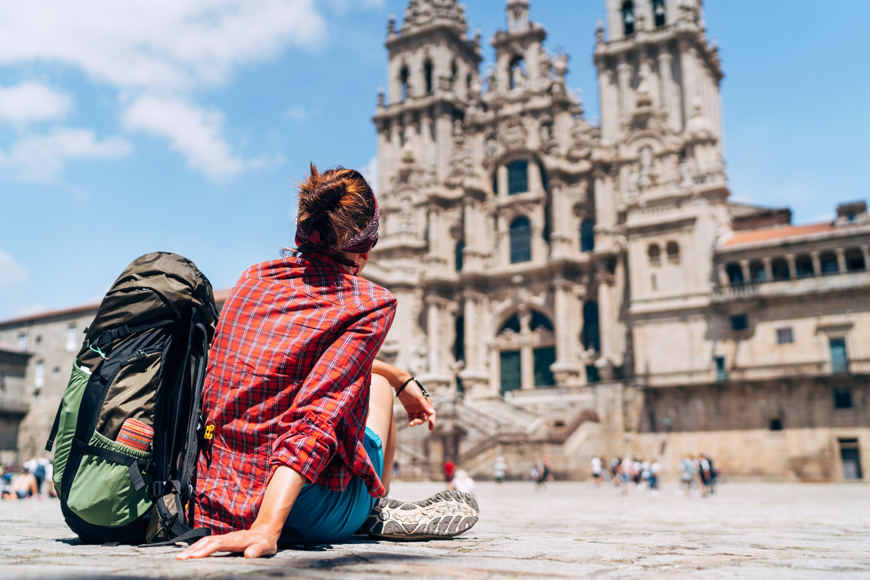 Pilgrim sitting on the Obradeiro square